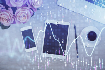 Double exposure of forex graph hologram over desktop with phone. Top view. Mobile trade platform concept.