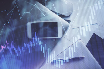 Multi exposure of forex graph hologram over desktop with phone. Top view. Mobile trade platform...