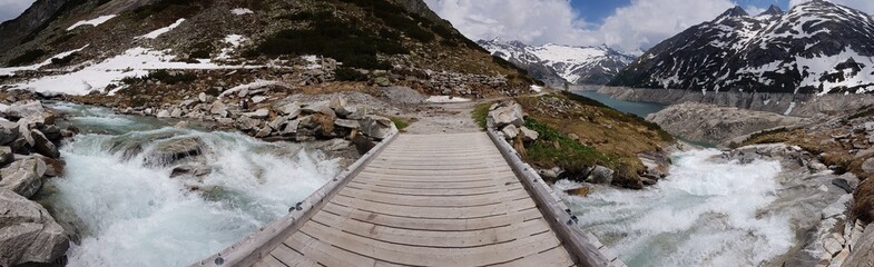 Panoramic picture of a small river flowing into the Kölnbreinspeicher lake in Austria