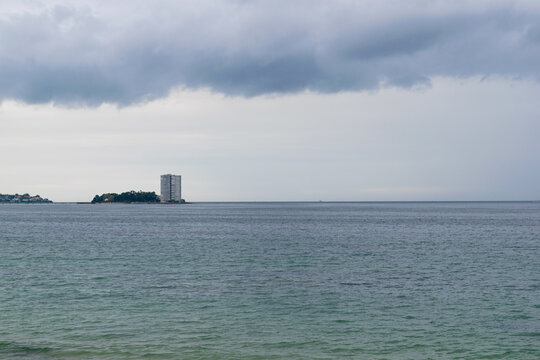 View of the island of Toralla during the day with a stormy sky. Vigo