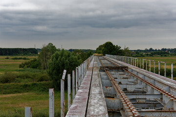 Abandoned steel railway bridge over the river.