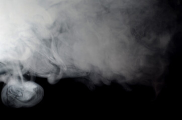 puffs of smoke thick on a black background close-up