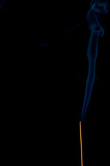 incense and smoke close-up on a black background
