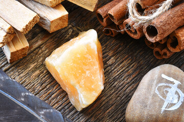 A top view image of white sage smudge stick with healing crystals, sacred feather and reiki symbol.