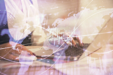Double exposure of businesswoman hands typing on computer and forex graph hologram drawing. Financial analysis concept.