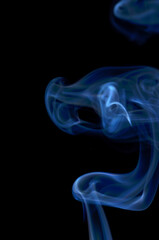 Smoke streaming on a black background close-up