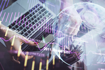 Double exposure of businesswoman hands typing on computer and financial graph hologram drawing. Stock market analysis concept.