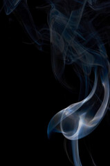 Smoke streaming on a black background close-up