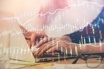 Multi exposure of woman hands typing on computer and financial graph hologram drawing. Stock market analysis concept.