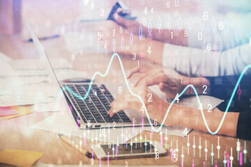 Multi exposure of woman hands typing on computer and financial chart hologram drawing. Stock market...