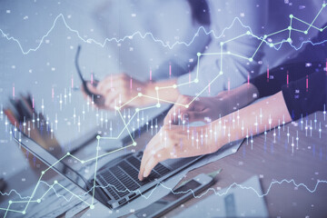Multi exposure of woman hands typing on computer and financial chart hologram drawing. Stock market...
