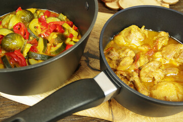 Homemade Chicken Curry with vegetables on the wooden tray. Closeup