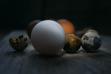 closeup of several eggs on beige white wood of chicken and quail egg some broken cordoba argentina
