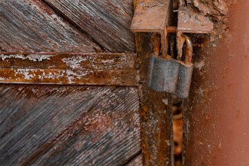old rusty padlock on a wooden door