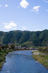 Fototapeta na wymiar An angler entering the Yoshida River in Gujo City, Gifu Prefecture