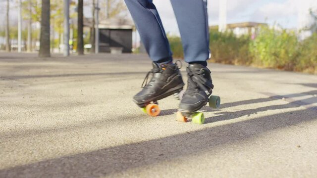 Young man on roller-skates going around in circles, in slow motion 