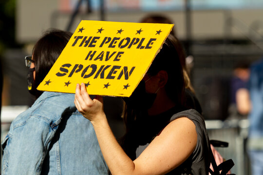 A Young Caucasian Woman In A Demonstration After US Election Is Holding A Sign That Says 