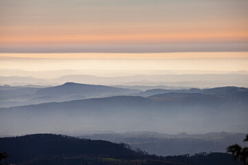 cloudy sky over misty mountain hills at sunset pastel colours landscape 
