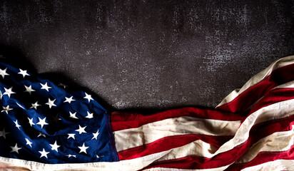 Happy Veterans Day concept. American flags against a dark stone  background. November 11.