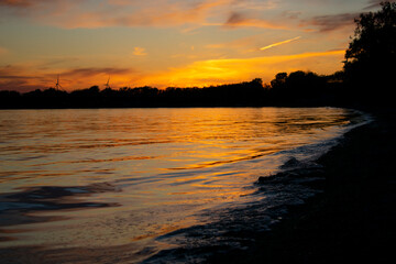 Orange Sunset Reflecting on Lake Shore