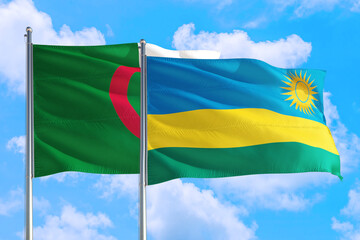 Rwanda and Algeria national flag waving in the windy deep blue sky. Diplomacy and international...