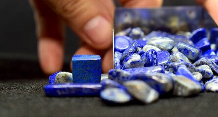 Lapis Is a beautiful natural gemstone on a wooden floor	