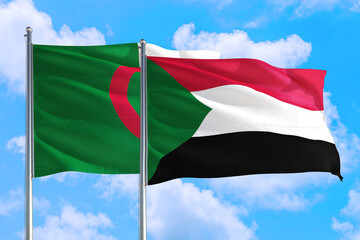 Sudan and Algeria national flag waving in the windy deep blue sky. Diplomacy and international...