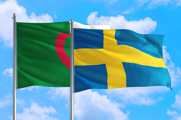 Sweden and Algeria national flag waving in the windy deep blue sky. Diplomacy and international...
