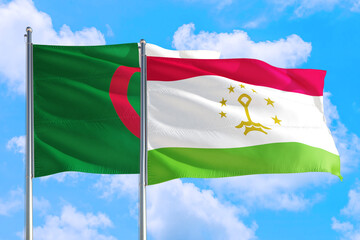 Tajikistan and Algeria national flag waving in the windy deep blue sky. Diplomacy and international relations concept.