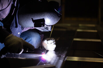 Metal workers use manual labor, Skilled welder, Factory workers making OT. Welder is welding the...