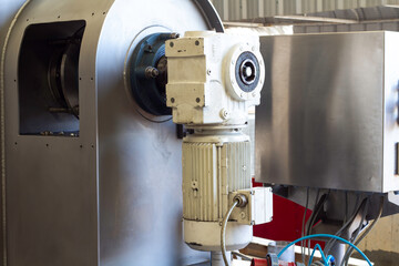 Old motor laid on the floor. The old motor is scrapped. Rusty old motor.