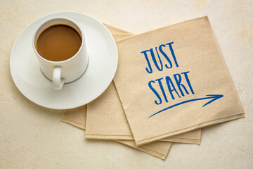 just start - motivational writing on a napkin with a cup of coffee, business and personal development concept