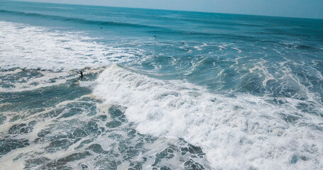 Mesmerizing shot of a surfer at the top of the wave in El Paredon beach in Monterrico, Guatemala