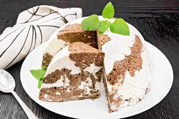Dessert of curd and chocolate a plate on wooden board