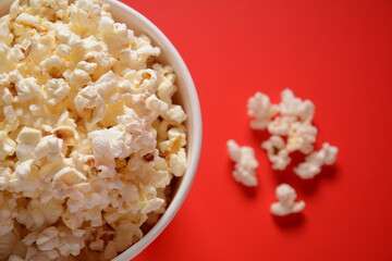 Buckets with delicious popcorn on red background 