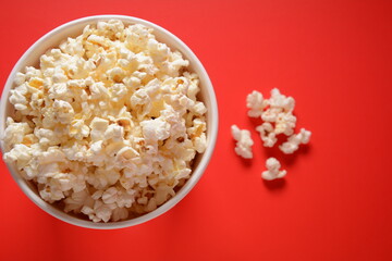 Buckets with delicious popcorn on red background 