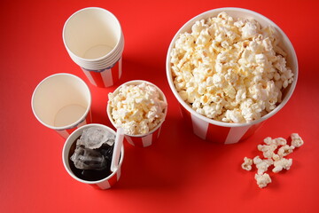 Buckets with delicious popcorn on red background 