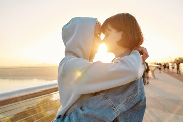 In love with you. Lesbian couple hugging on the bridge, looking at each other while admiring the...