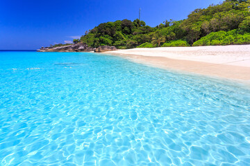 Clear water and blue sky on a sunny day of Similan Islands National Park.