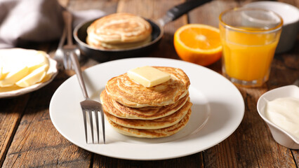 pancake with orange juice on table