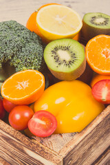 Fresh fruits with vegetables in rustic box as food containing healthy minerals and vitamins. Vintage photo