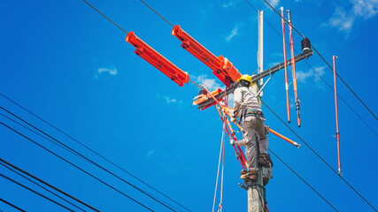 The lineman used tie stick to carve the tie wire used to wrap the electrical wires attached to the...