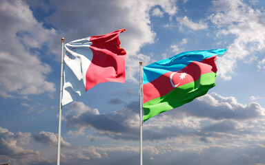 Beautiful national state flags of Malta and Azerbaijan together at the sky background. 3D artwork concept.
