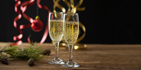 Christmas background, champagne glasses on a wooden surface