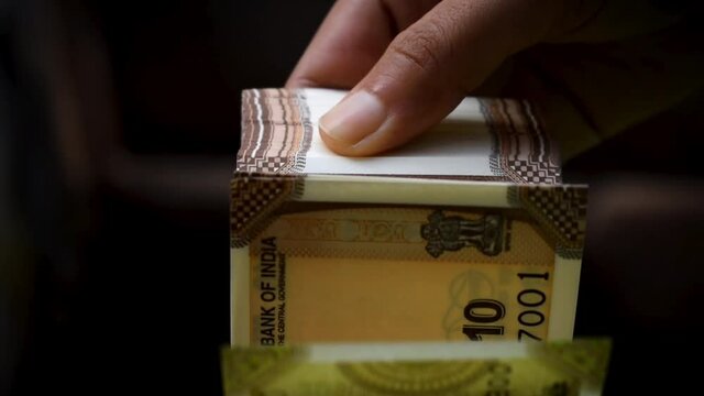 Superfast Indian currency notes counting by women hand.