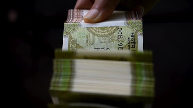 Superfast Indian currency notes counting by women hand.