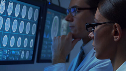 Professional medical doctors are maksing computer research in hospital office. Medicine, healthcare and neurosurgery concepts.