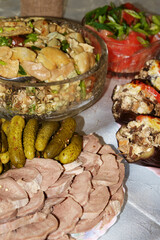 Festive table. Boiled pork tongue with pickles and spices, salted mushrooms seasoned with herbs, stuffed eggplant.