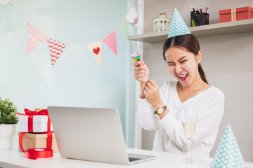 Asian woman count down and pull party popper to celebrate new year party via video call conference, new normal for birthday, Christmas and new year party at home