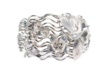 Silver bracelet decoration with flowers, butterfly and dragonfly design isolated on white background. large silver bracelet decorative with flowers and insect pattern isolated